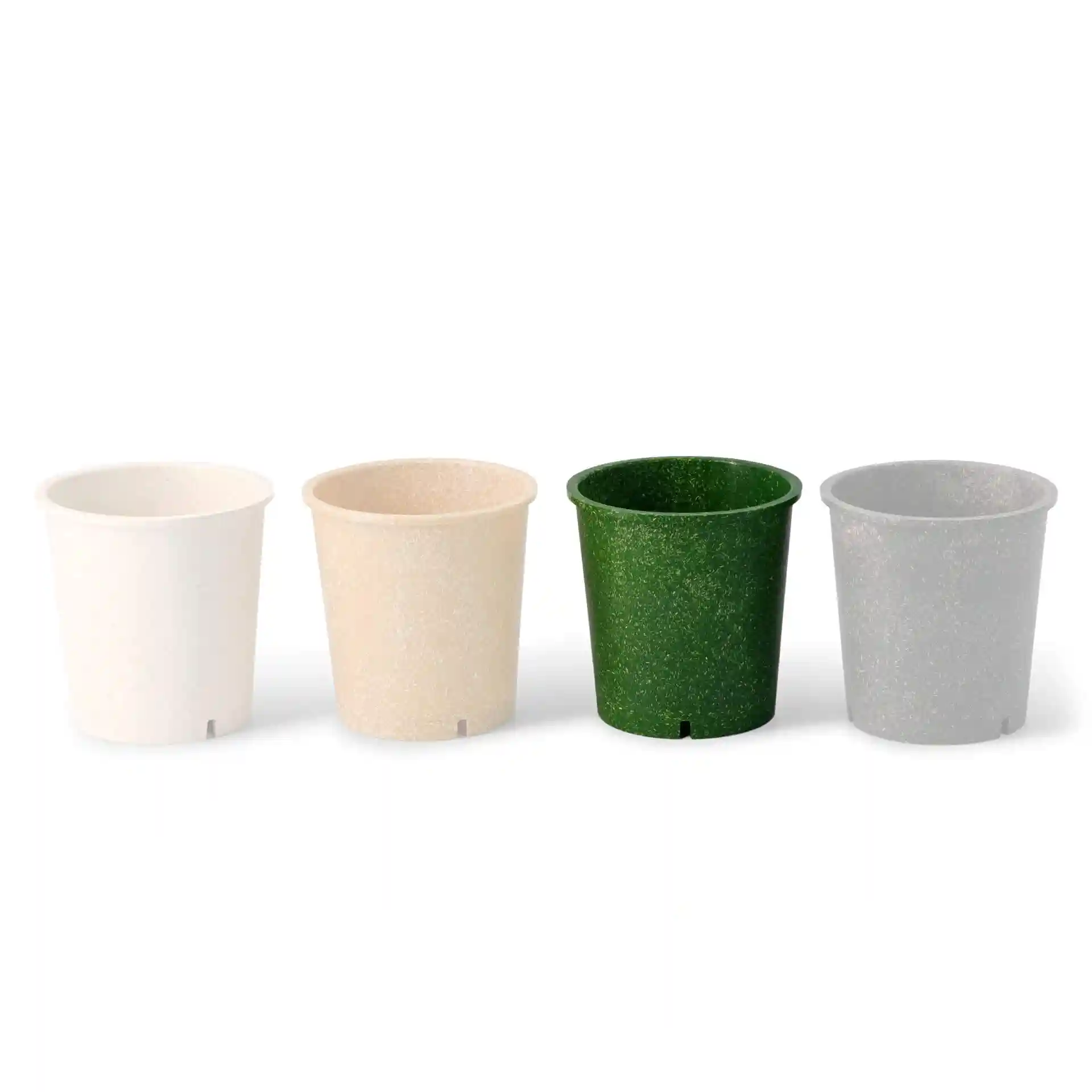 Four reusable cups in white, beige, green, and gray, each with a round shape and a drainage hole at the bottom.