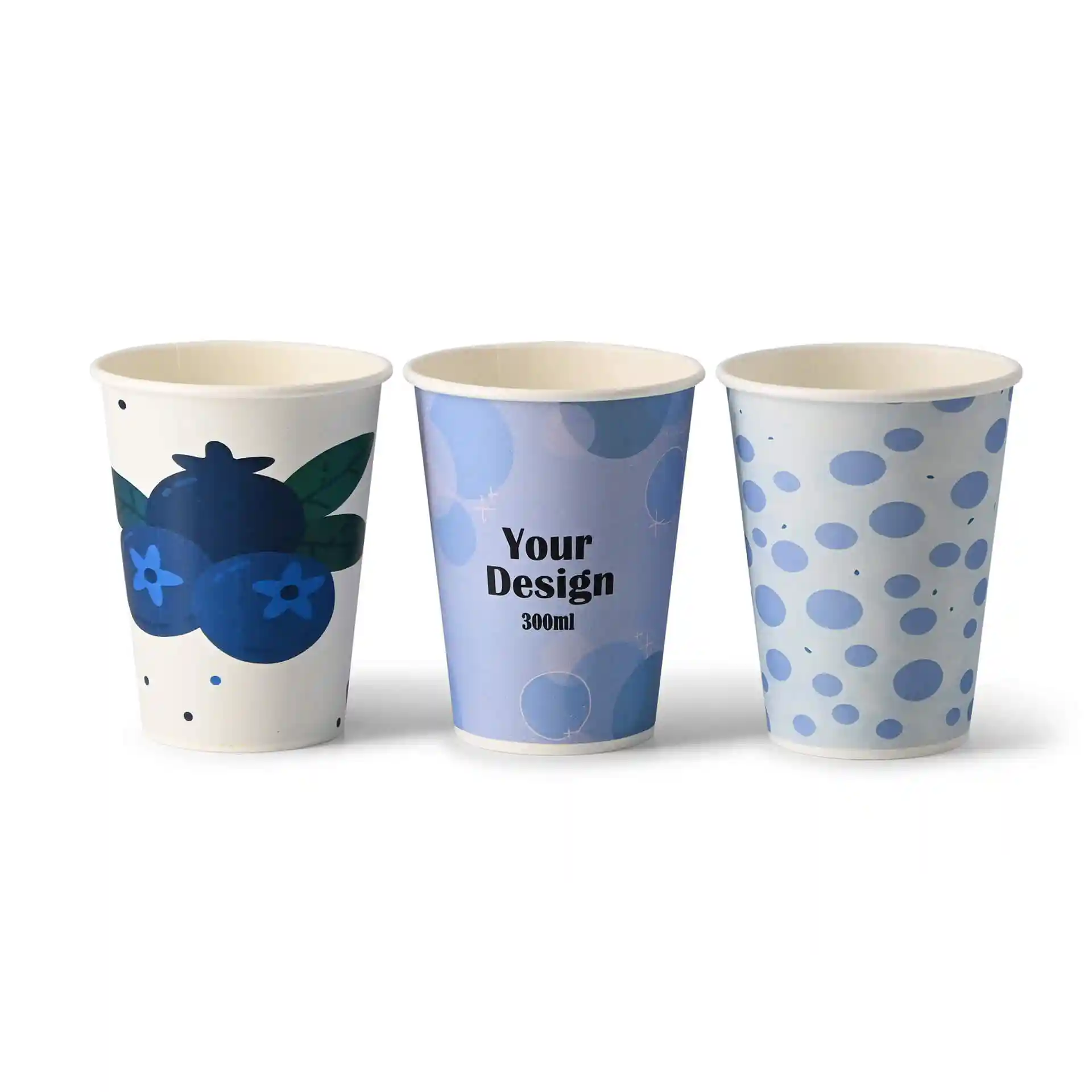 Three paper cups with different designs: one with blueberries, one with a blue pattern, and one with text.