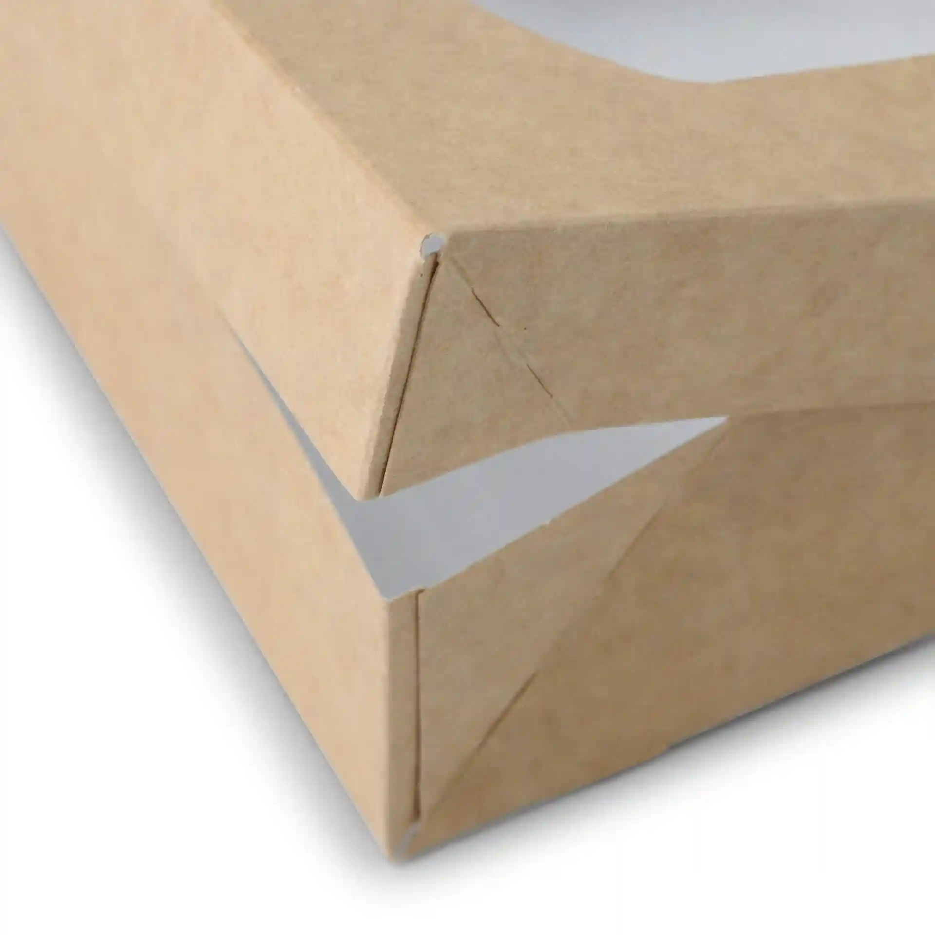 Close-up of a brown cardboard window box with a white interior, showing the corner and folding detail.