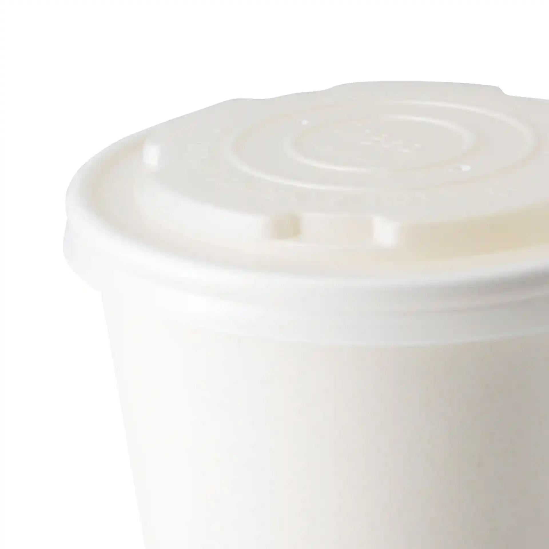White CPLA flat lid with a round shape, designed for universal cups, shown from an angled top view.