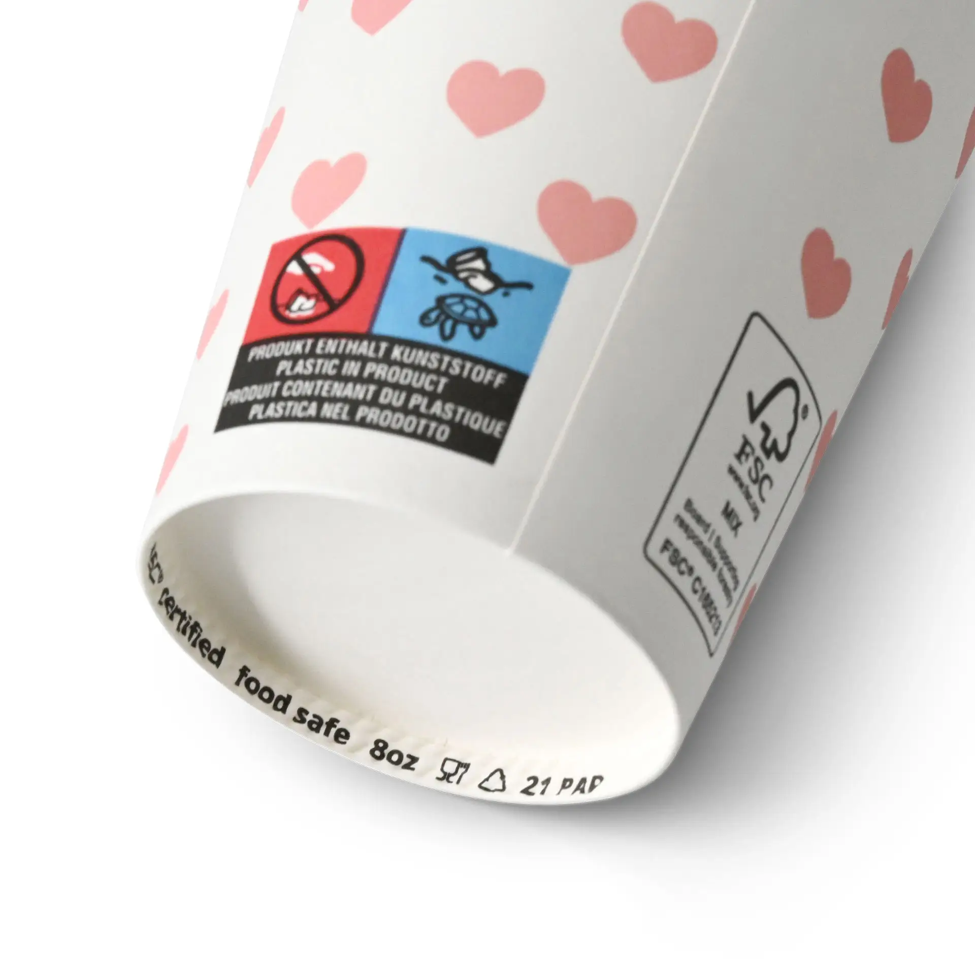 One white paper cup with a hearts print; features a food-safe label and two warning symbols on its side.