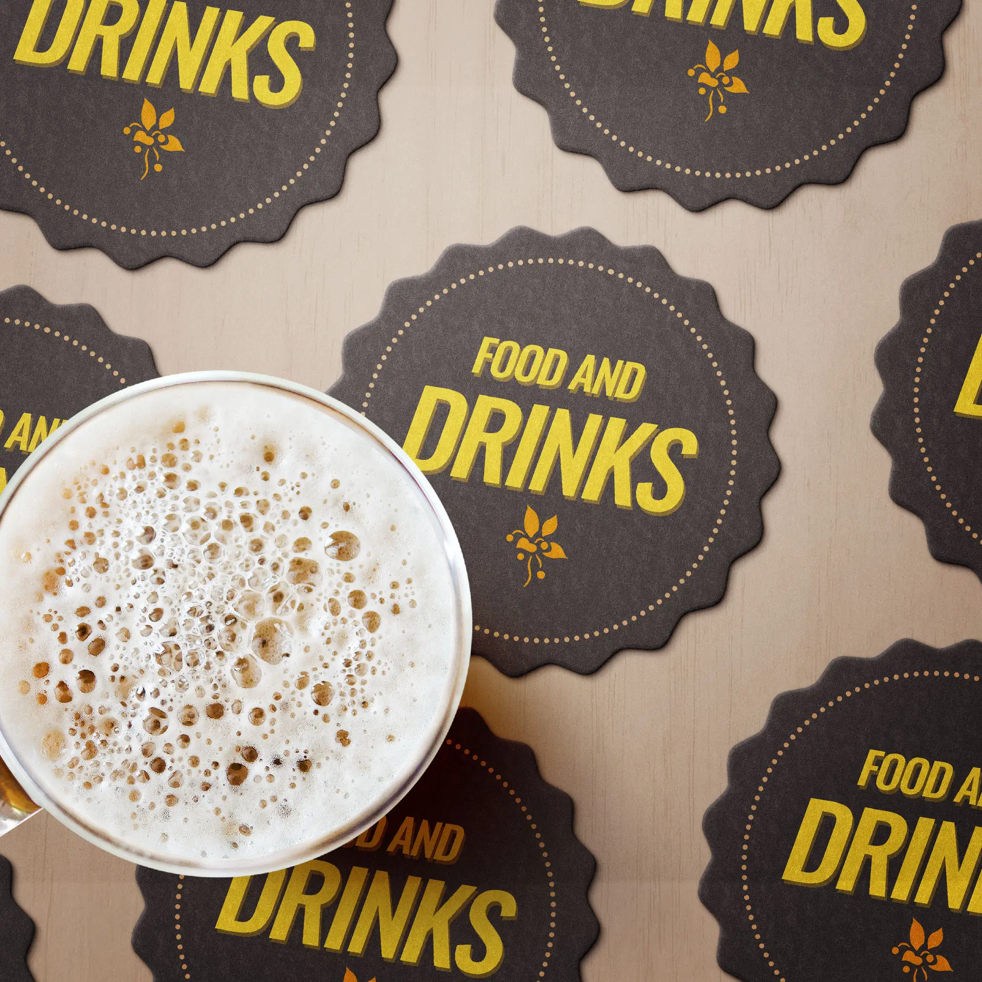 A glass of beer placed on several printed bottle cap-shaped coasters featuring the text "FOOD AND DRINKS."
