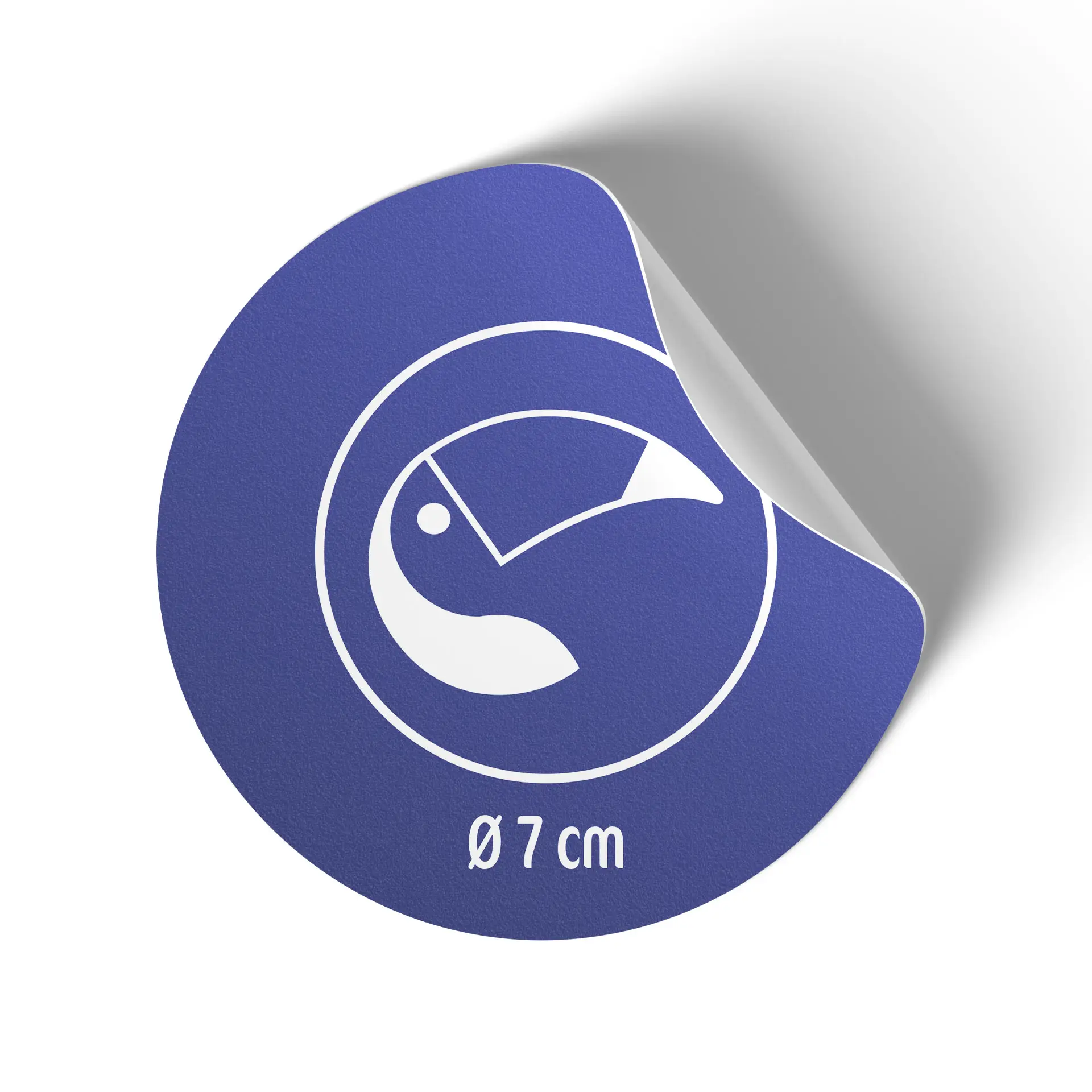 Round 7 cm white matte printed label roll with a blue design and a symbol, partially peeled back.